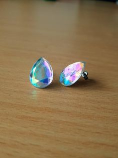 Gorgeous iridescent colour changing teardrop titanium earring studs, they change from beautiful tones of blue/green/pink with the angle and lighting  These acrylic crystal earrings are made on Grade 1 nickel free, hypoallergenic titanium posts and backs They measure 18mm in length, and 11mm at the widest point  Photographed alongside a 5p coin for size reference  Perfect for anyone with metal sensitivities, or nickel allergies Iridescent Hypoallergenic Drop Earrings, Iridescent Teardrop Hypoallergenic Jewelry, Iridescent Drop Earrings For Pierced Ears, Iridescent Drop Earrings For Gift, Hypoallergenic Teardrop Crystal Earrings For Party, Iridescent Hypoallergenic Earrings For Party, Hypoallergenic Iridescent Earrings For Parties, Sparkling Teardrop Crystal Earrings For Gifts, Iridescent Drop Earrings For Jewelry Making