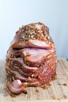 sliced ham sitting on top of a wooden cutting board