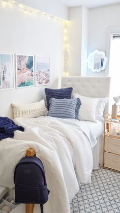 a bed with white sheets and blue pillows in a room decorated for christmas or new year's eve