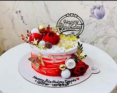 a red and white birthday cake sitting on top of a table