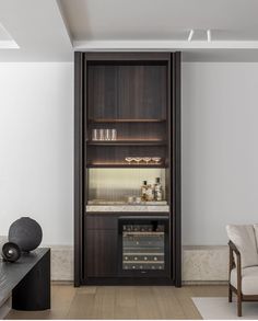 a living room with some chairs and a book shelf