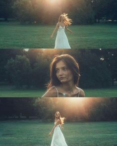 a woman in a white dress is walking through the grass with her hair blowing in the wind