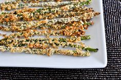 asparagus with parmesan cheese and seasoning on a white platter