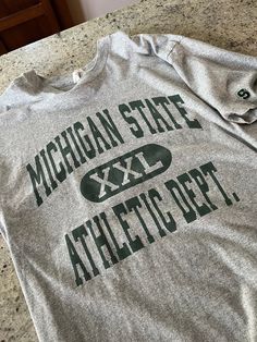 Athletic Department Shirt, Athletic Dept Shirts, Vintage College T-shirt With Lettering, Vintage Crew Neck Tops With Lettering, Vintage Gray T-shirt With Text Print, Vintage T-shirt With Lettering For College, Retro Crew Neck Top With Lettering, Vintage Lettering T-shirt For College, Vintage Gray Tops For College