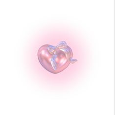 a pink heart shaped object with a bow on it's side, against a white background