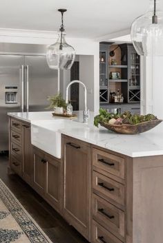 a large kitchen with wooden cabinets and white counter tops