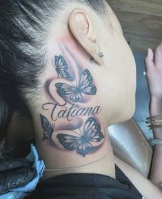 a woman with a tattoo on her neck and behind her ear that says tattoama