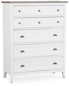 a white chest of drawers with wooden top