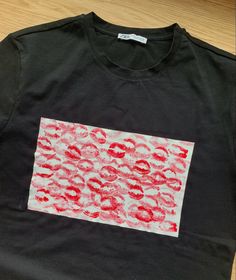 a black t - shirt with red lips on it