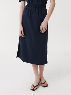 This is a clean and casual skirt by EAAH that is made out of high quality and sturdy fabric. With unique design detail and trendy mood, you can style it for your refined and casual daily outfit.- Side seam pocket- Set up with matching blouse- Elastic banding and string and stopper detail- Semi A line silhouette Workwear Skirt With Elastic Waistband And Relaxed Fit, Relaxed Fit Skirt With Elastic Waistband For Workwear, Chic Cotton Skirt With Side Pockets, Cotton Skirt With Relaxed Fit For Work, Casual Relaxed Skirt With Slip Pockets, Casual Skirt With Slip Pockets And Relaxed Fit, Relaxed Fit Cotton Skirt For Work, Navy Cotton Lined Skirt Bottoms, Navy Cotton Summer Skirt