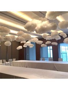 clouds are hanging from the ceiling above tables