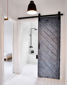 an open barn door in a white room