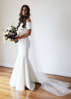 a woman in a wedding dress holding a bouquet