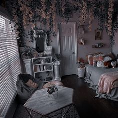 a bedroom decorated in pink and grey with flowers on the ceiling