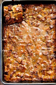 a casserole with meat and gravy in a pan on a wooden table