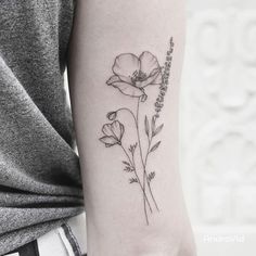 a woman's arm with a flower tattoo on the left side of her arm