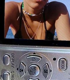 a woman is posing in front of a cell phone with her face close to the camera