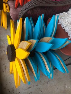 colorful wooden sunflowers and other decorative items on display