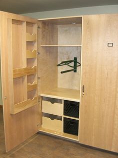 an empty closet with wooden shelves and drawers