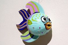 a colorful fish ornament hanging on a wall