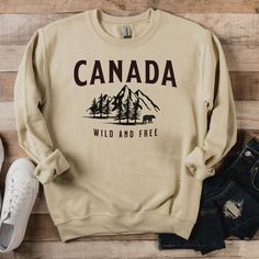 "Designed with comfort and style in mind, our \"Canada Wild and Free\" sweatshirt features a stunning mountainscape scene with a majestic bear, symbolizing the untamed wilderness of Canada. The cozy fabric ensures a warm and soft feel, making it your go-to choice for chilly days or cozy nights by the campfire. Show your love for Canada and its breathtaking landscapes while expressing your adventurous spirit. The \"Canada Wild and Free\" sweatshirt is a great conversation starter and an ideal gift for fellow travelers, nature lovers, and anyone who cherishes the beauty of this great country. Whether you're exploring the great outdoors or simply enjoying the comforts of home, our \"Canada Wild and Free\" sweatshirt will keep you snug and stylish on all your journeys. Embrace your Canadian pr Fellow Travelers, Custom Teacher Gifts, Freedom Shirts, Mountain Shirt, Travel Shirt, Cozy Fabric, Embroidered Crewneck, Canadian Rockies, Mama Sweatshirt