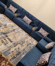 a blue couch with pillows on top of it