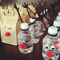 some bottles and bags are sitting on a table with reindeer noses in front of them