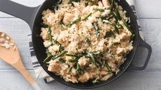 a skillet filled with rice and green beans