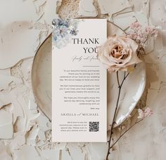 a thank card on a plate next to flowers and a piece of paper that says, thank you