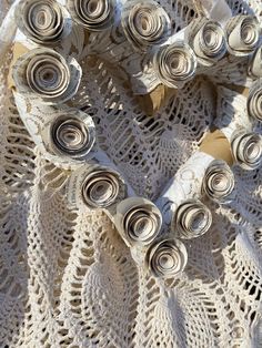 several rolls of rolled up paper sitting on top of a doily