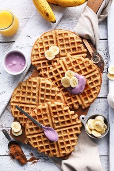 two waffles with bananas and blueberry yogurt sauce on the side