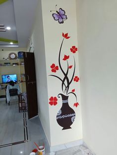 the wall is painted with flowers and butterflies in black and white, as well as a vase