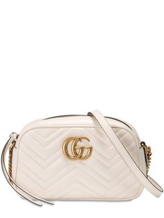 Find Gucci Gg Marmont Leather Camera Bag on Editorialist. Height: 13cm Width: 24cm Depth: 7cm. Shoulder strap length: 60cm. Metal chain shoulder strap with leather insert. Top zip closure . Front metal logo detail. Gold colored metal hardware. One internal patch pocket Luxury White Bags With Metal Logo, Designer Crossbody Shoulder Bag With Metal Logo, White Gucci Shoulder Bag With Chain Strap, Designer Shoulder Bag With Metal Logo For Travel, Gucci Luxury Shoulder Bag With Adjustable Strap, Gucci Leather Shoulder Bag With Metal Hardware, Gucci Classic Shoulder Bag With Chain Strap, Classic Gucci Shoulder Bag With Chain Strap, Chic Gucci Shoulder Bag With Metal Logo