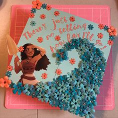 a cake decorated with blue flowers and a hula girl on it