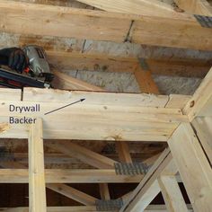 an image of a house being built with wood framing and tools on the roof area