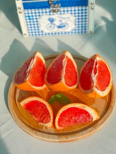 grapefruit cut in half on a wooden plate