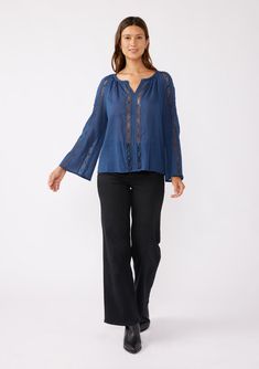 A classic bohemian top with crochet trim and long flared sleeves. Cotton Relaxed fit Long bell sleeves Split v-neckline Crochet trim Sheer Women's bohemian top The dreamiest top for any season. This classic bohemian blouse features long bell sleeves, a split v-neckline, and delicate crochet trim throughout. Perfect for warmer weather or layered for cooler days, it pairs beautifully with vintage denim and a simple sandal or boot. Model is 5'9, wearing a size S.Style: I-15321W-SQV Bohemian Tunic Top With Lace Trim, Bohemian Flowy Top With Crochet Trim, Bohemian Flowy Tops With Crochet Trim, Flowy Bohemian Top With Crochet Trim, Bohemian V-neck Crochet Top For Fall, Fall Bohemian V-neck Crochet Top, Bohemian Crochet V-neck Top For Fall, Blue Bohemian Top With Crochet Trim, Bohemian Beach Peasant Top With Lace Trim