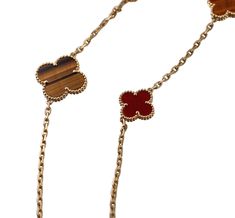 18k yellow gold Magic Alhambra 16 motif necklace by Van Cleef & Arpels, with carnelian and tiger's eye. Current retail $28000. Necklace comes in VCA pouch. DESIGNER: Van Cleef & Arpels MATERIAL: 18k Gold GEMSTONES: Tiger's eye, Carnelian DIMENSIONS: Necklace is 47.25" long. Clovers measure from 15 x 15mm to 25 x 25mm. MARKED/TESTED: VCA, 750, BL273***. WEIGHT: 62 grams CONDITION: Previously Owned, Excellent Condition. Luxury Carnelian Jewelry For Formal Occasions, Luxury Brown Jewelry With Polished Finish, Elegant Brown Necklace With Polished Finish, Luxury Gold Carnelian Jewelry, Luxury Red Necklaces, Luxury Brown Jewelry With Gemstone, Luxury Brown Gemstone Jewelry, Elegant Carnelian Necklaces In Yellow Gold, Elegant Yellow Gold Carnelian Necklace