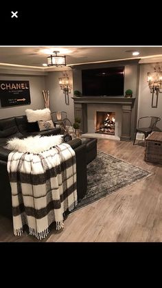 a living room filled with furniture and a fire place in the middle of the room