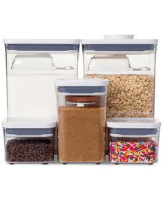 three storage containers filled with cereal, cereal and sprinkles on a white background