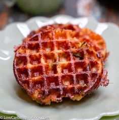 two waffles sitting on top of a white plate next to eachother