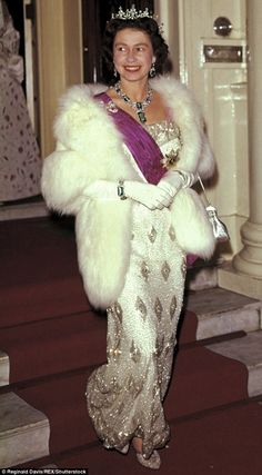 a woman in a gown and fur coat