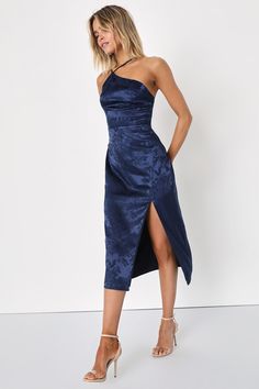 Arrive like a vision and leave everyone stunned in the Lulus Desirable Dream Navy Blue Satin Jacquard Halter Neck Midi Dress! Sleek woven satin jacquard (embossed with a pretty floral design) creates a modified, asymmetrical halter neckline and a princess-seamed bodice, supported by adjustable spaghetti straps. High, fitted waist sits atop a figure-skimming midi skirt with a sexy side slit. Hidden back zipper/clasp. Fit: This garment fits true to size. Length: Mid-calf length. Size medium measur Navy Blue Satin Dress, Halter Neck Midi Dress, Blue Satin Dress, Winter Wedding Guest Dress, Blue Halter Dress, Navy Blue Midi Dress, Fall Wedding Guest Dress, Lulu Fashion, Blue Cocktail Dress