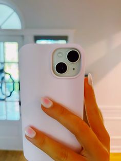 a woman's hand holding up an iphone case