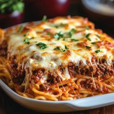 a close up of a plate of spaghetti with meat sauce and parmesan cheese