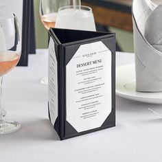 a table with wine glasses and menus on it