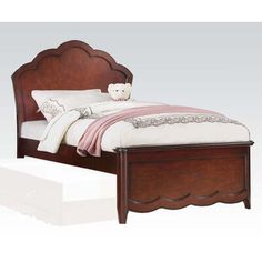 a bed with a wooden headboard and foot board on top of it's frame