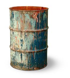 an old rusted metal barrel with paint splattered on the side and bottom