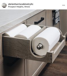 two rolls of toilet paper are in the drawer