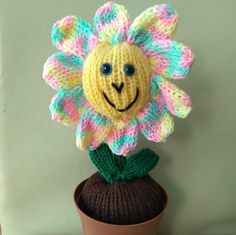 a crocheted flower sitting on top of a pot